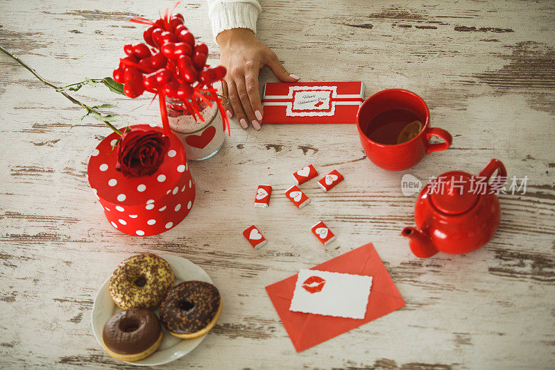 Preparing Valentine’s celebration with red decorative items